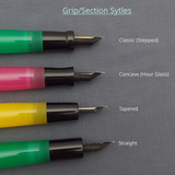 Four fountain pens with different nib types are shown on a gray textured background with text labels: Classic (Stepped), Concave (Hour Glass), Tapered, and Straight. The grips show green, pink, yellow, and green colors.